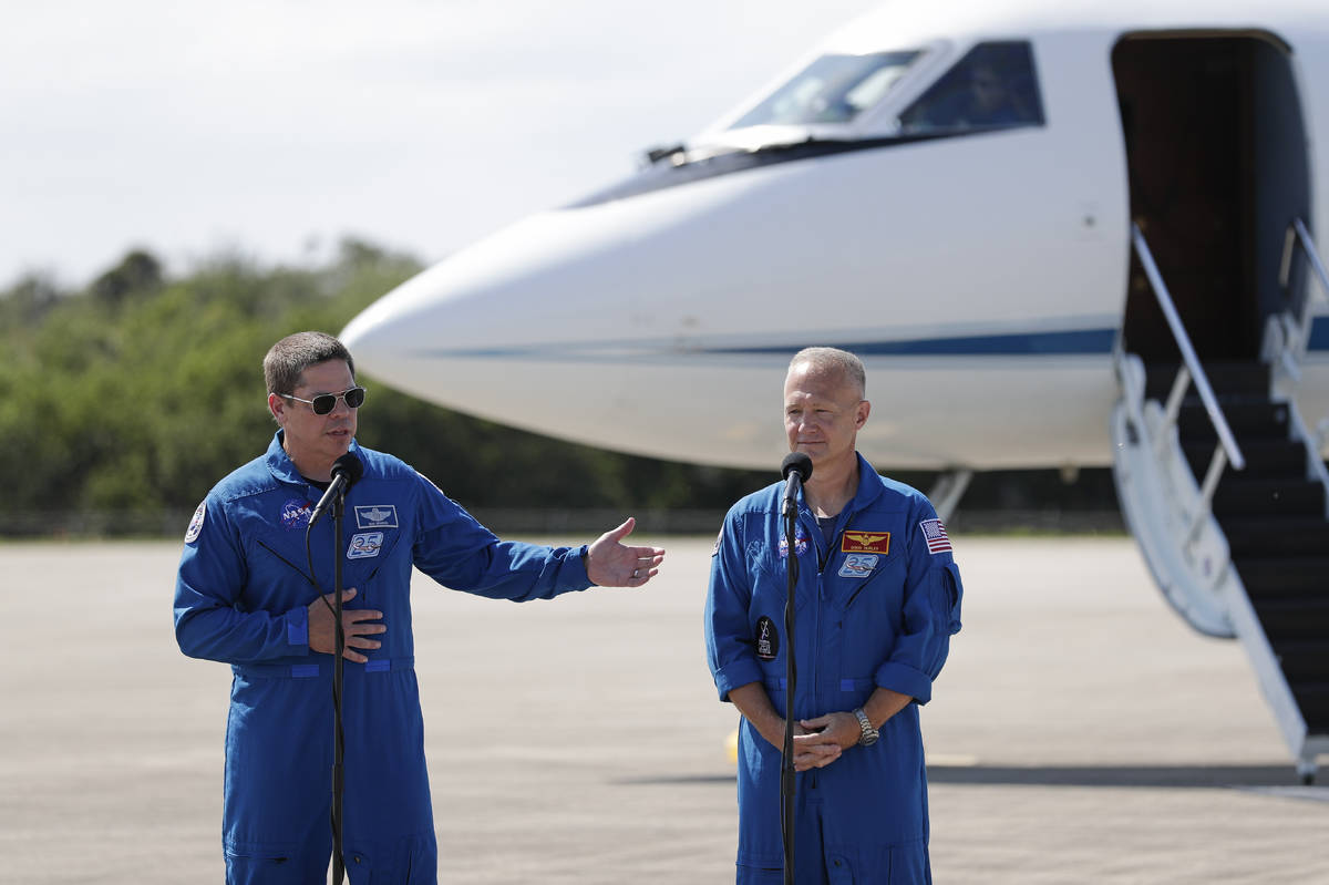 NASA astronauts Robert Behnken , left, and Doug Hurley speak during a news conference after the ...