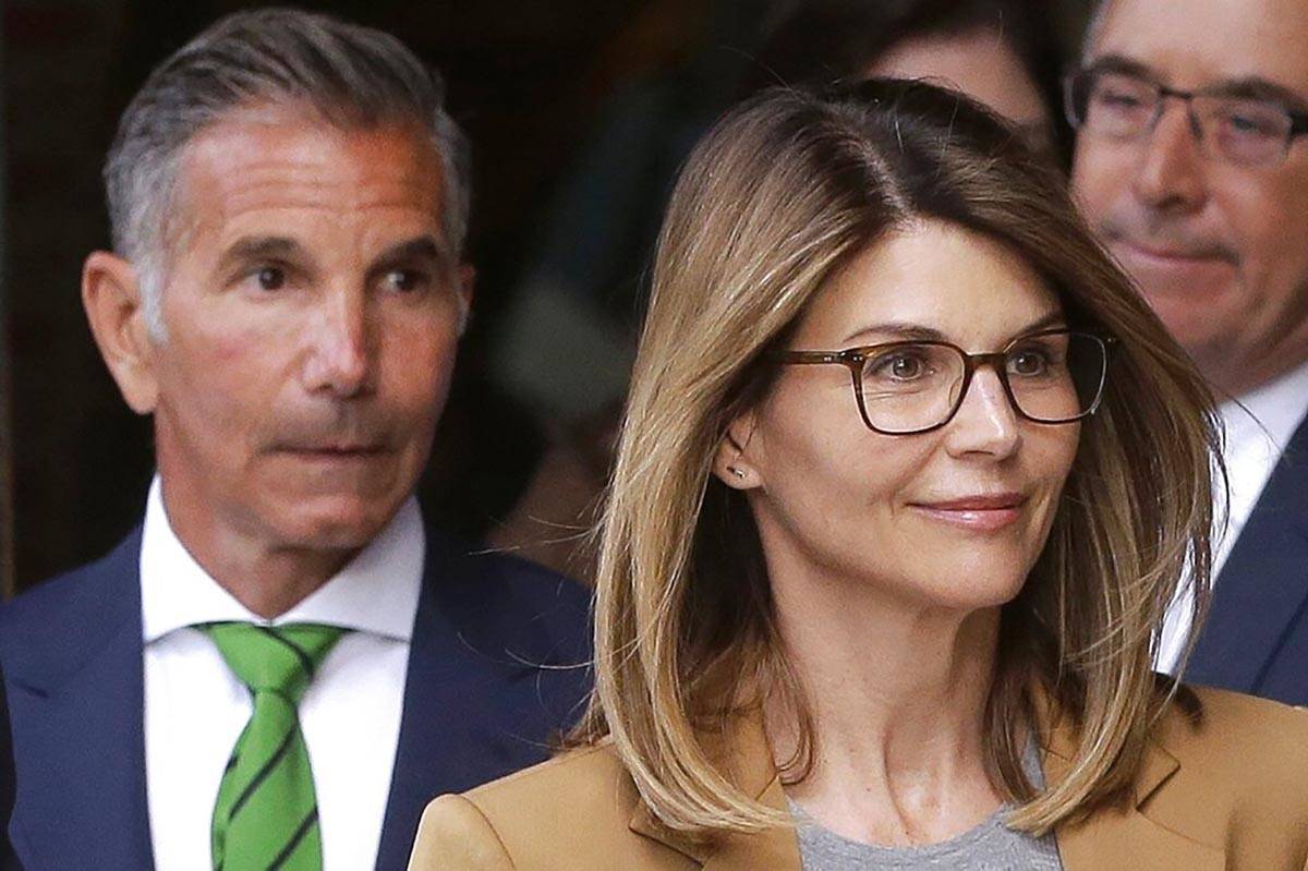 In a April 3, 2019, file photo, actress Lori Loughlin, front, and her husband, clothing designe ...