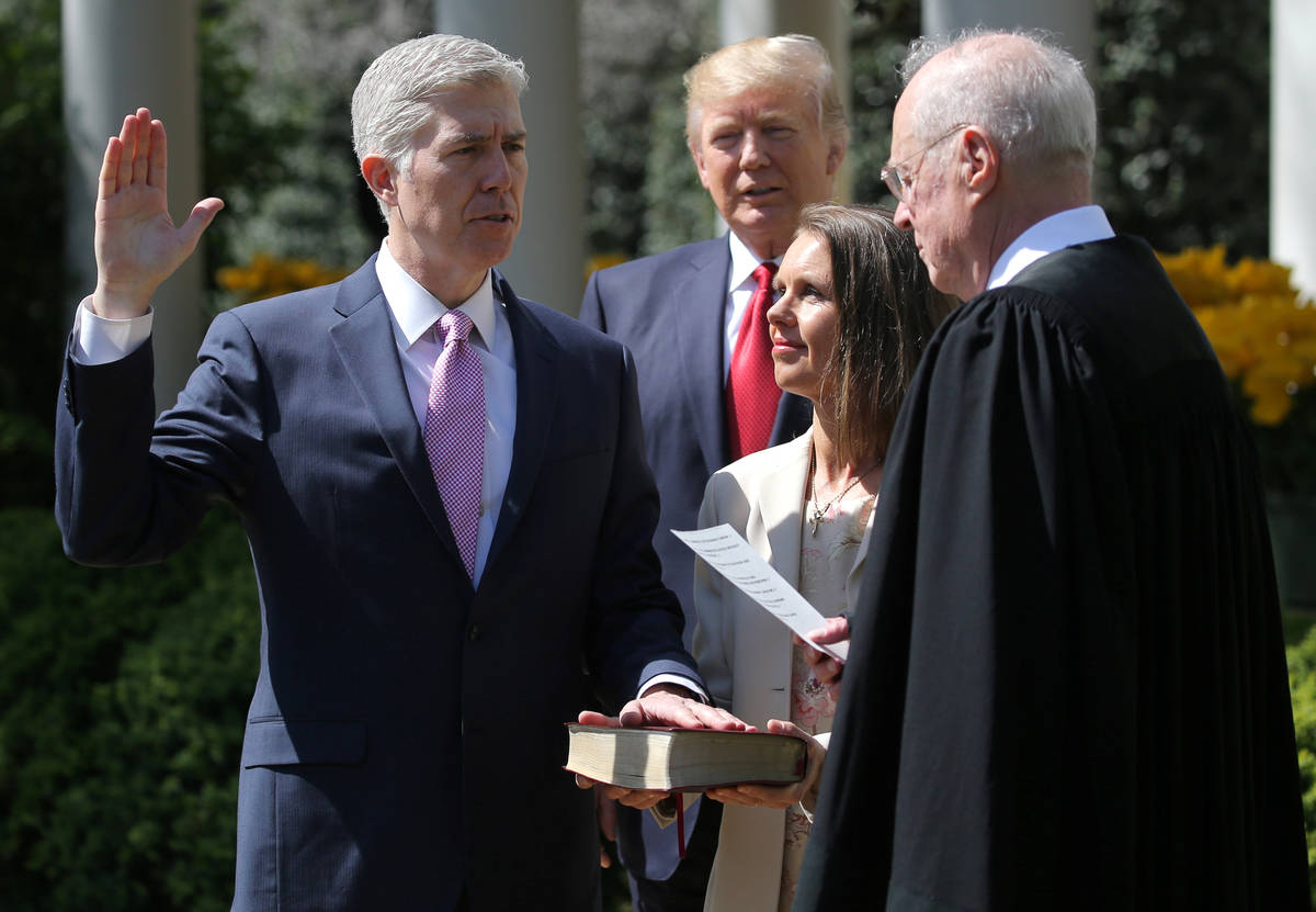 FILE PHOTO: Judge Neil Gorsuch (L) is sworn in as an associate justice of the Supreme Court by ...