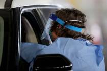 Registered nurse Megan Ryan works at the COVID-19 testing facility in the parking garage at The ...