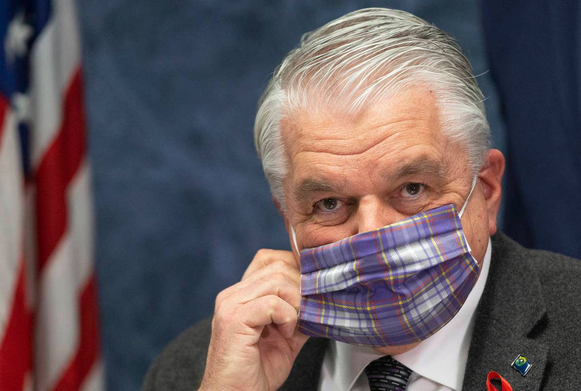 Gov. Steve Sisolak wears a protective mask before the start of a press conference, April 8, 202 ...