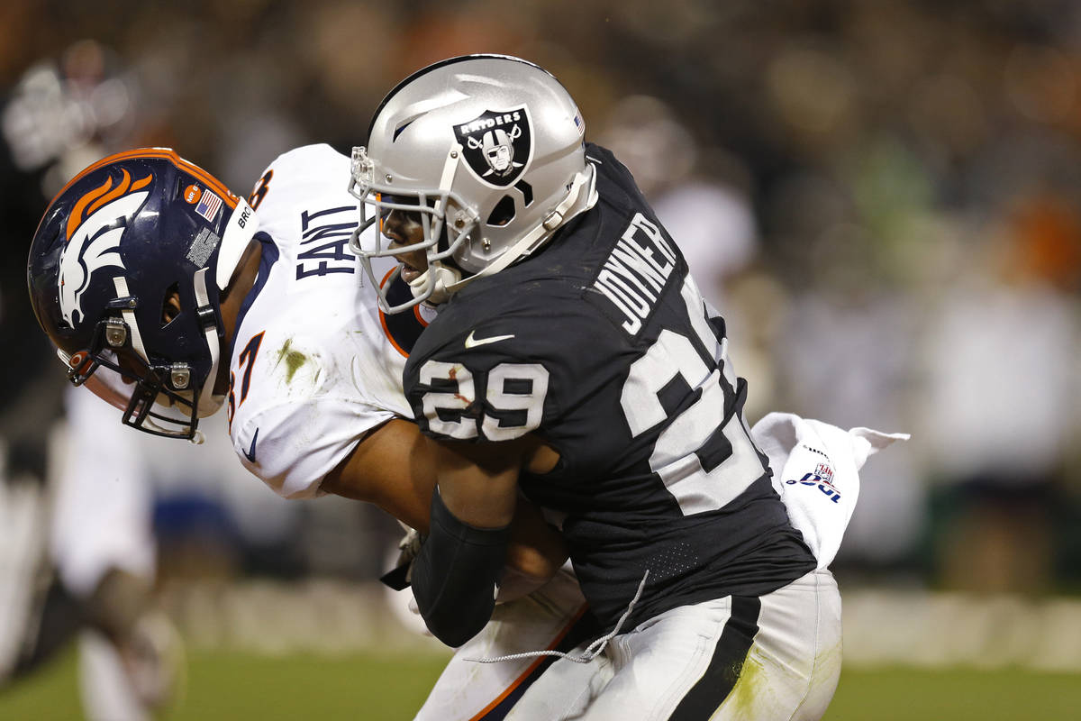 Denver Broncos tight end Noah Fant is stopped by Oakland Raiders free safety Lamarcus Joyner (2 ...
