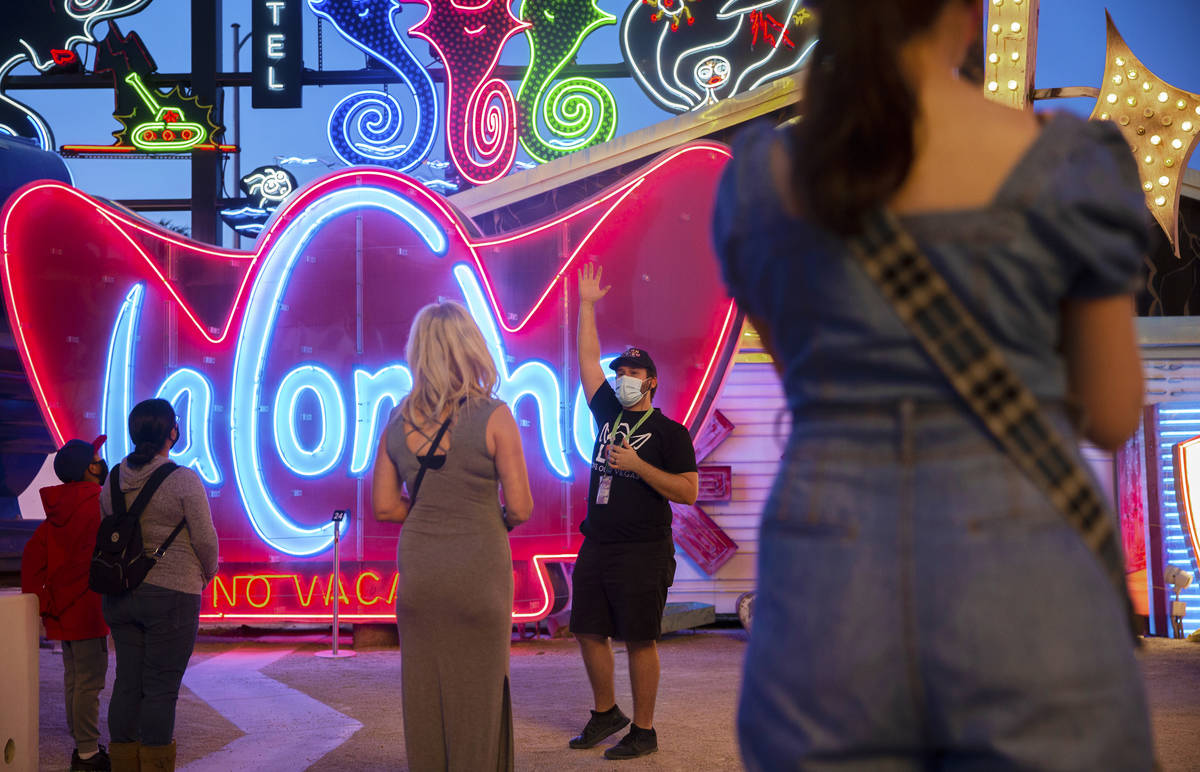 Interpreter Wyatt Currie, second from right, leads a tour at The Neon Museum on Friday, May 22, ...