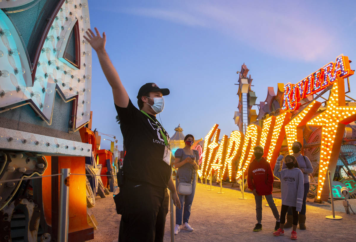 Interpreter Wyatt Currie, left, leads a tour at The Neon Museum on Friday, May 22, 2020, in Las ...