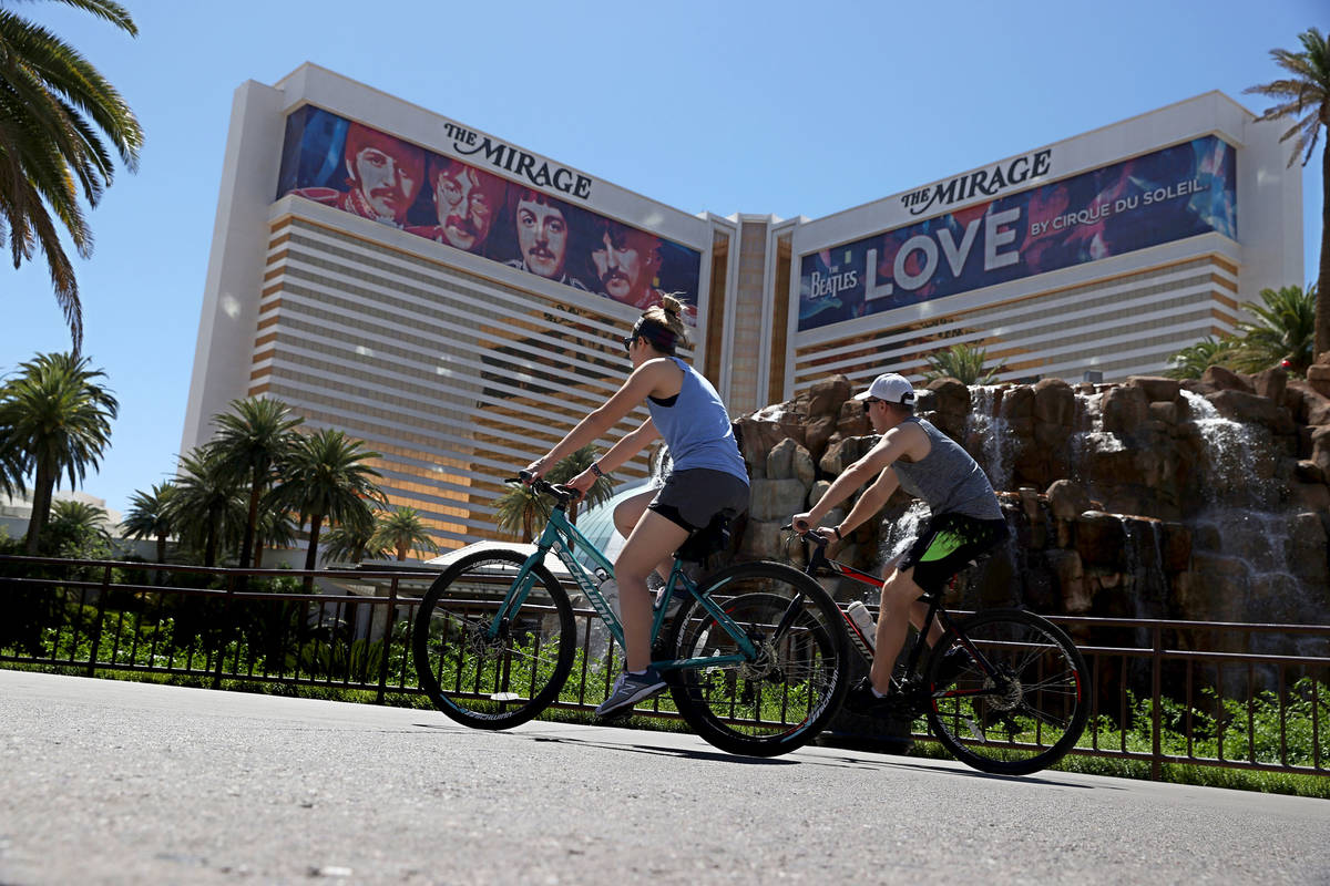 People ride their bikes at the Strip near The Mirage hotel-casino in Las Vegas, Saturday, May 2 ...