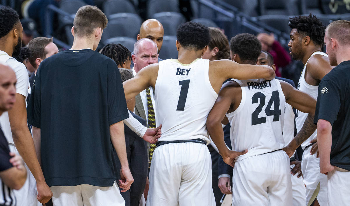 Colorado guard Tyler Bey (1) gathers with teammates for a timeout versus Wyoming during the fir ...