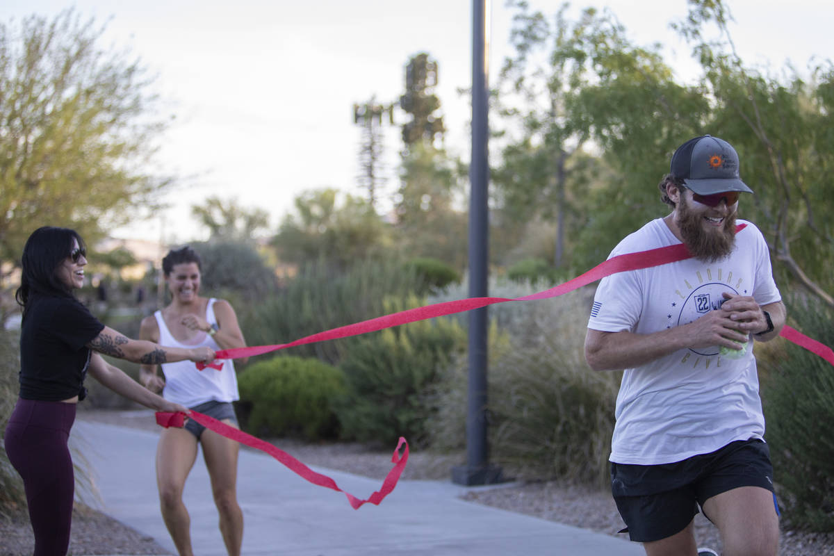 Peter Makredes runs through streamers during his eleventh hour of running around Exploration Pe ...