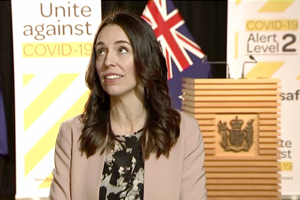 In this image made from video, New Zealand Prime Minister Jacinda Ardern looks up when an earth ...