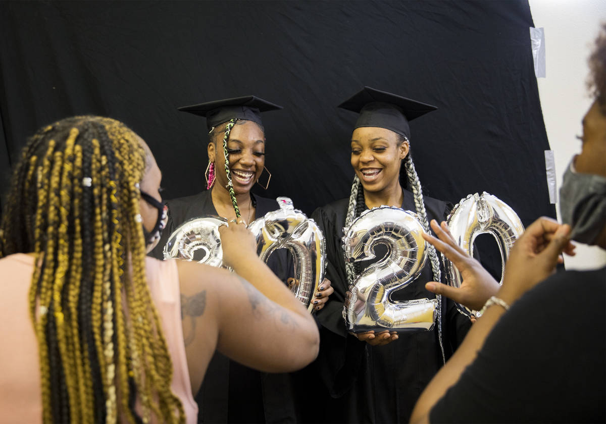 Destiny England, 17, left, and her friend Le 'Quitta Ragland, 18, prepare to have their high sc ...