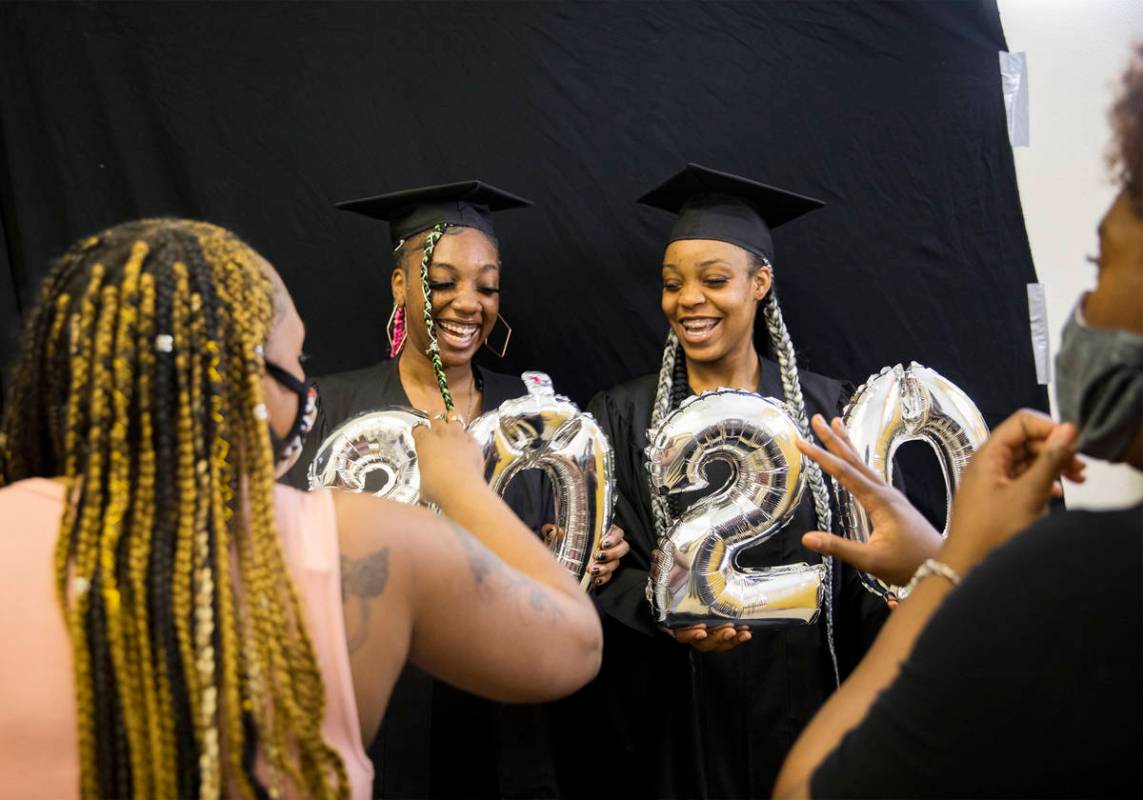Destiny England, 17, left, and her friend Le 'Quitta Ragland, 18, prepare to have their high sc ...