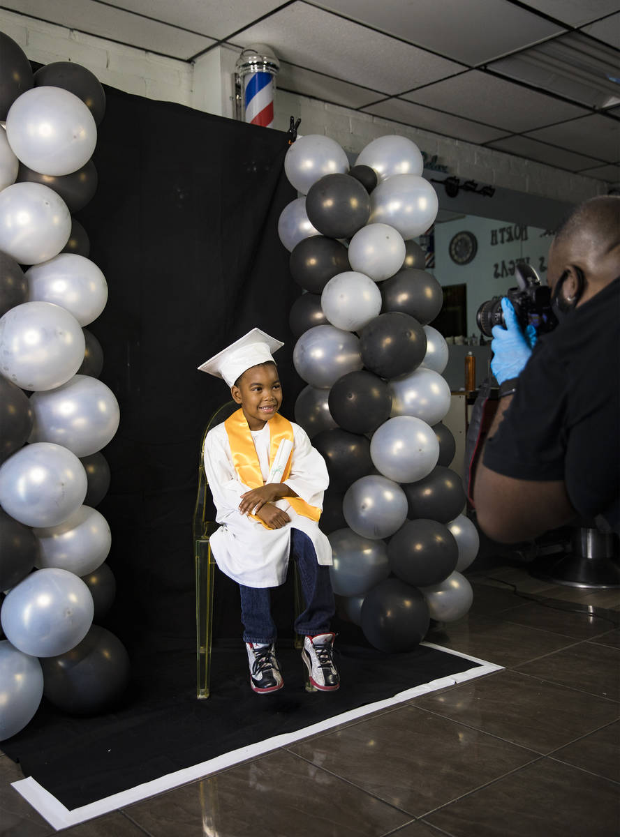 Dr. Dillard A. Scott takes a photo of Jourdyn Carson, 6, for his kindergarten graduation at Mr. ...