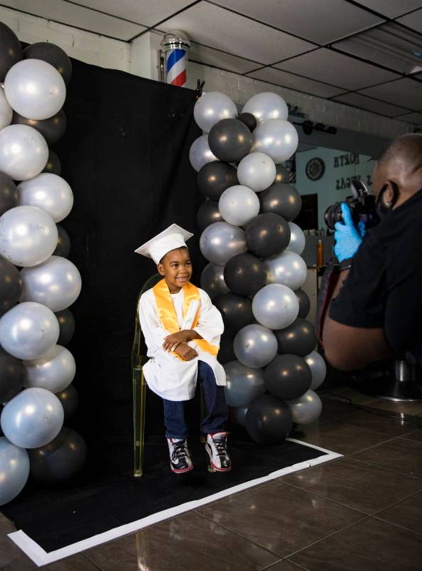 Dr. Dillard A. Scott takes a photo of Jourdyn Carson, 6, for his kindergarten graduation at Mr. ...