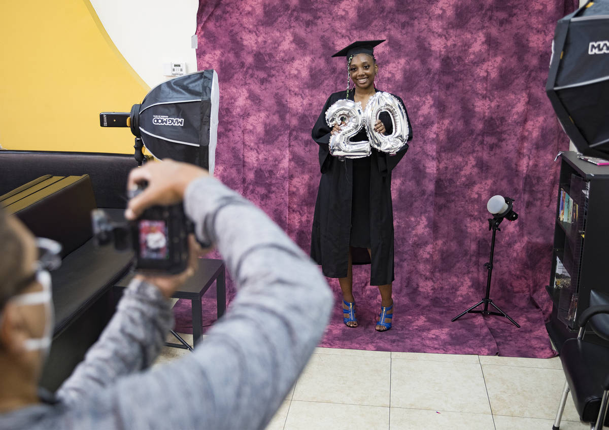Herb Holder takes a photo of Destiny England, 17, for her high school graduation at 5 Star Barb ...