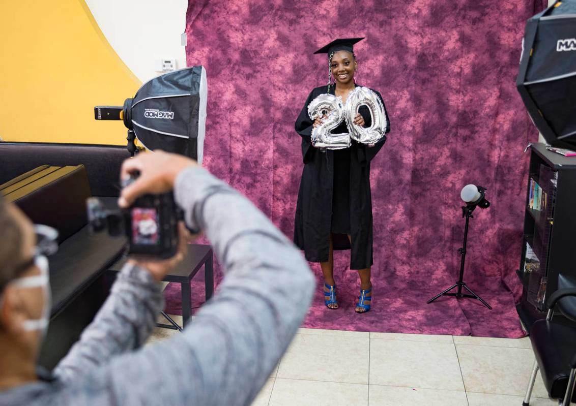 Herb Holder takes a photo of Destiny England, 17, for her high school graduation at 5 Star Barb ...