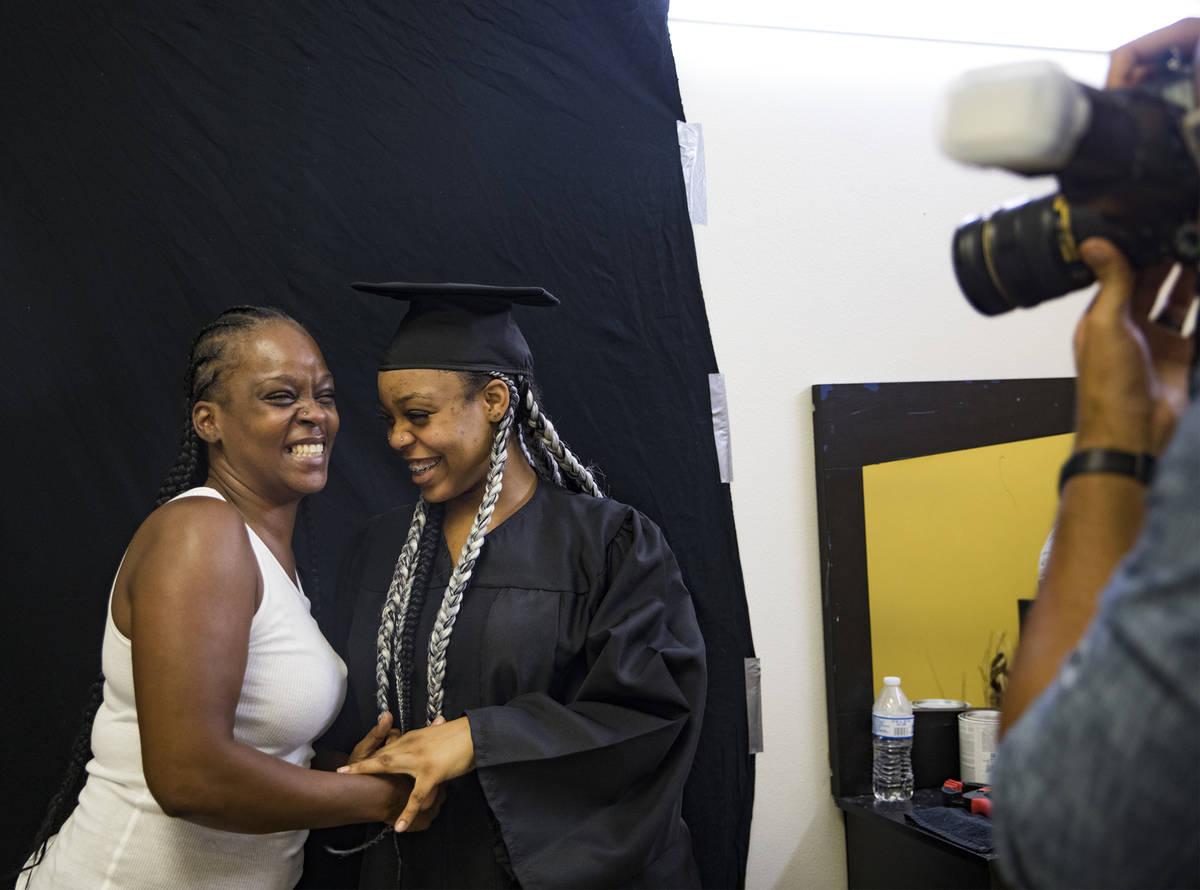 Kamika Adams laughs with her daughter Le 'Quitta Ragland, 18, as Julian Kemper takes a photo fo ...