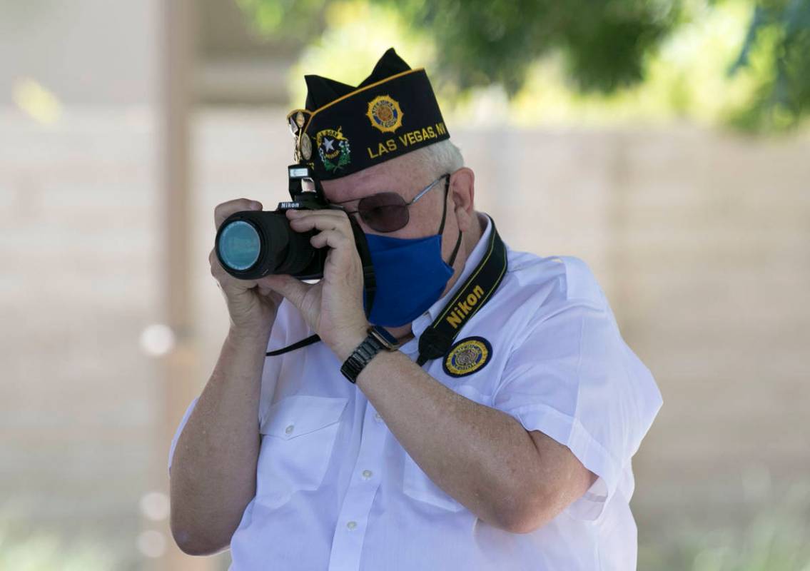 U.S. Army Sgt. Roger Henning takes a photo during the 18th Annual Lakes Memorial Day ceremony a ...