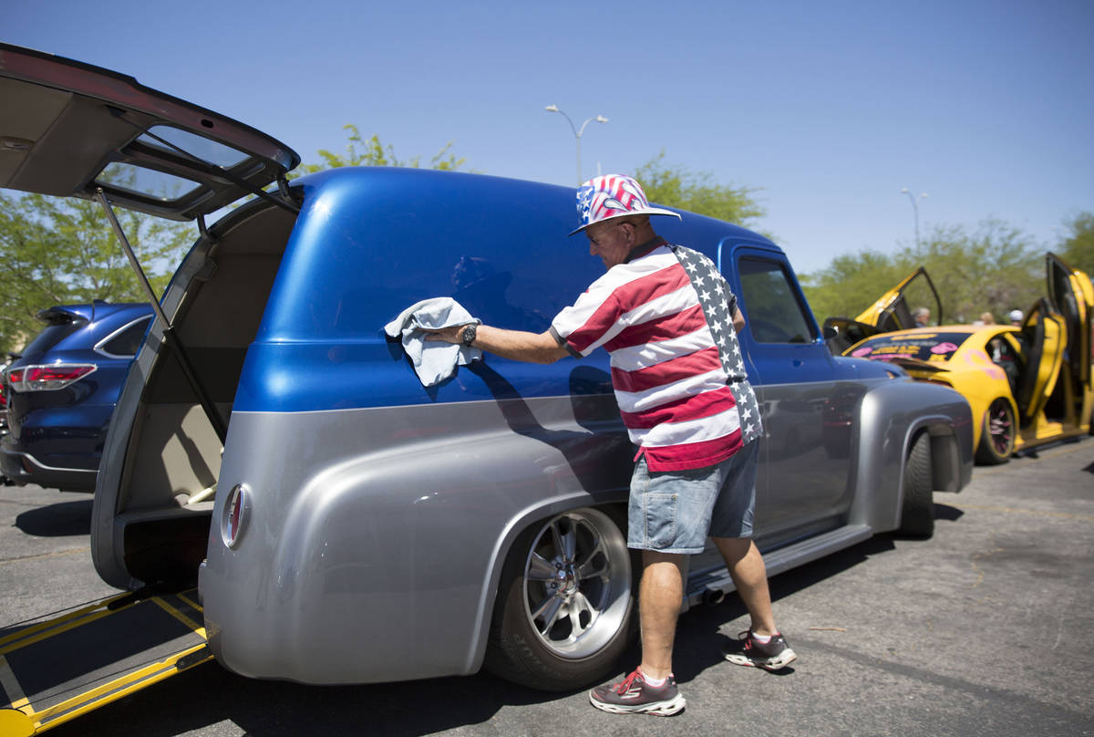 Brad Kreutzer cleans a 1954 Ford Panel as he waits to participate in the first “Hot Rods for ...