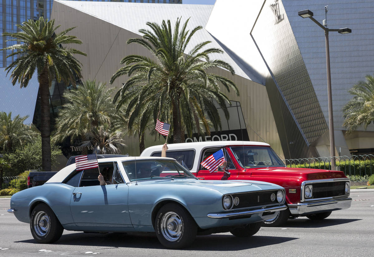 Classic cars and other vehicles participate in the first “Hot Rods for Heroes” by cruising ...