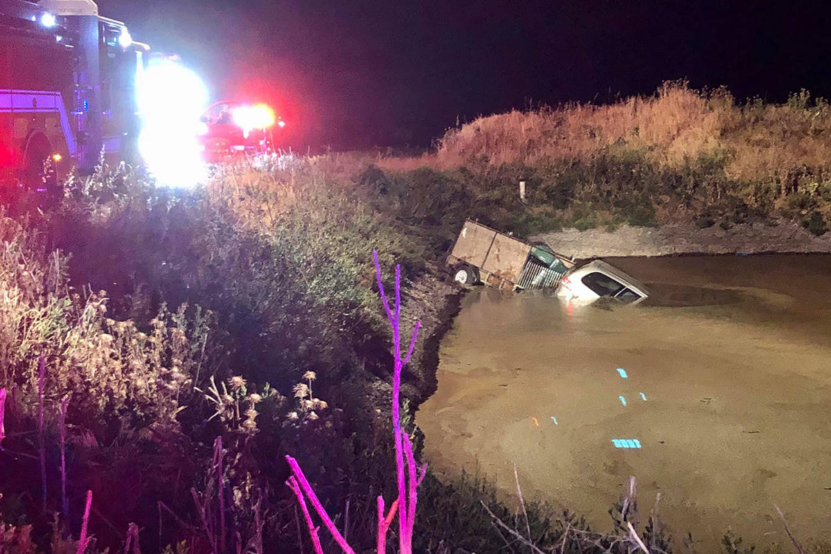 A vehicle is partially submerged in a manure pond Monday, May 25, 2020, in South Sacramento, Ca ...