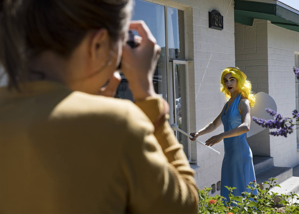 Holly Rae Vaughn takes a photo of Victoria Hogan, dressed as the Blue Angel statue from the fo ...