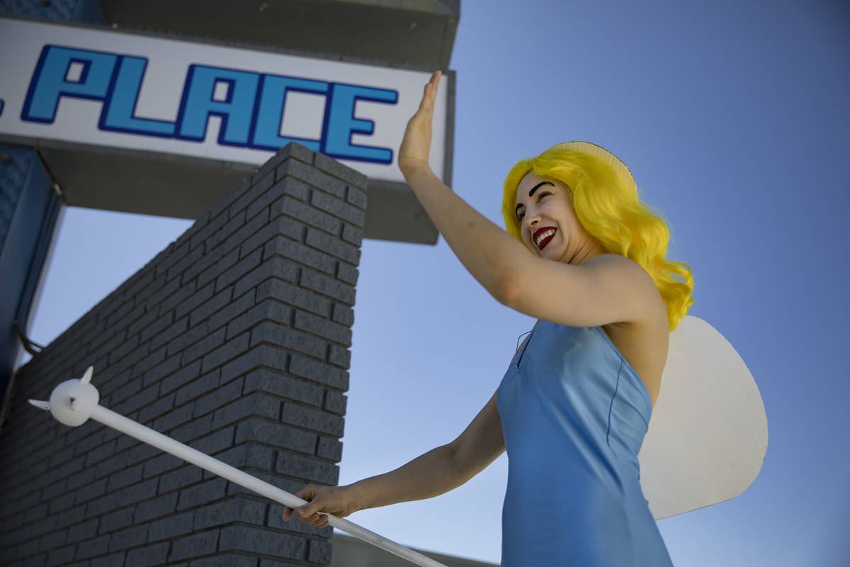 Victoria Hogan, dressed as the Blue Angel statue from the former Blue Angel Motel, waves at bys ...