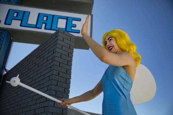 Victoria Hogan, dressed as the Blue Angel statue from the former Blue Angel Motel, waves at bys ...