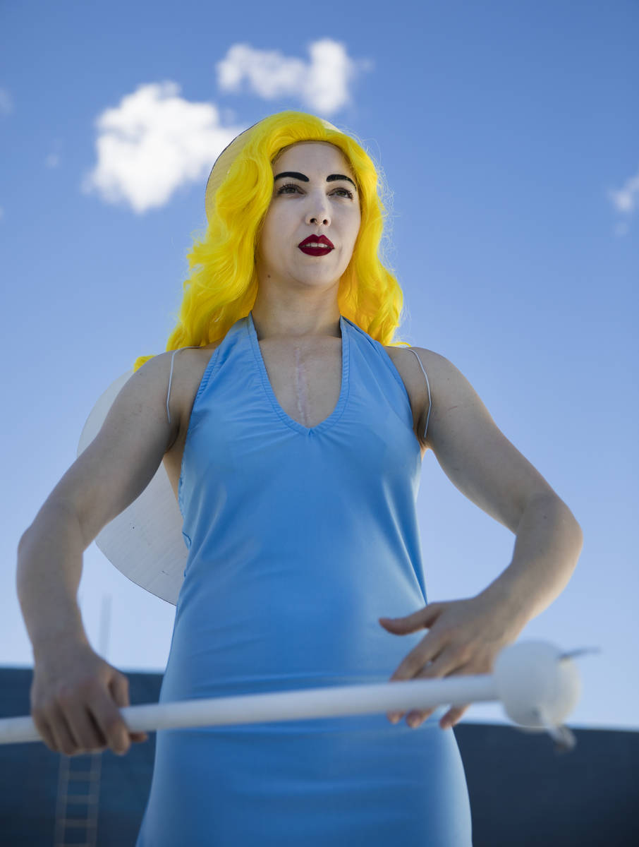 Victoria Hogan, dressed as the Blue Angel statue from the former Blue Angel Motel, stands on to ...