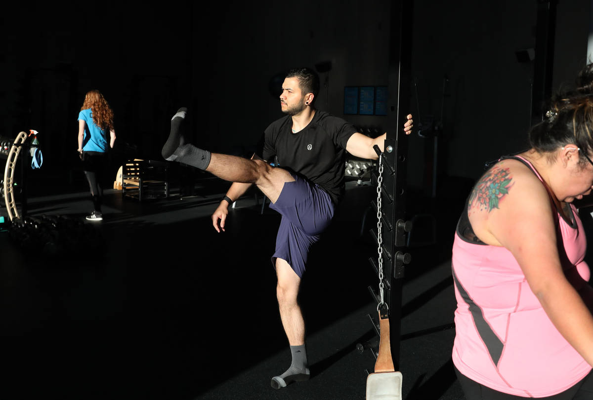 Brian Lee, member of The Gym Las Vegas, partakes in strength training while following social di ...