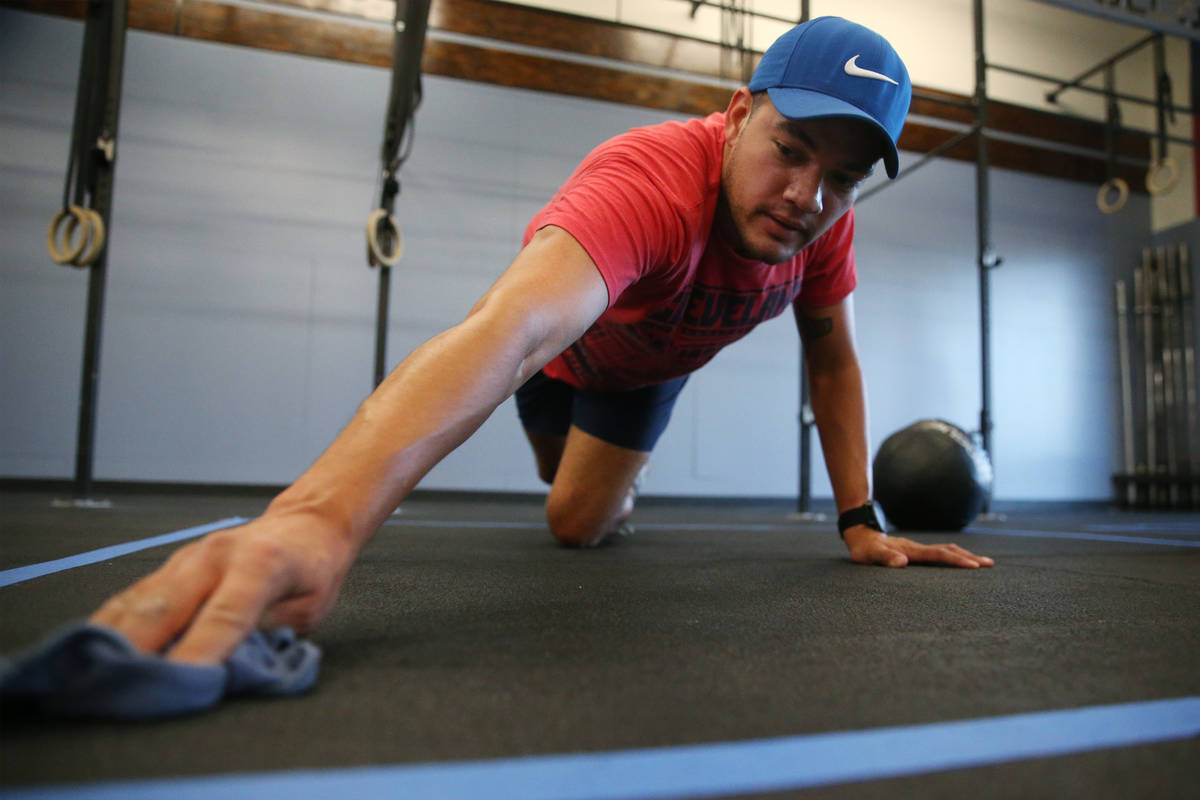 Peter Rivera cleans his space after working out at Crossfit Apollo in Las Vegas, Friday, May 29 ...