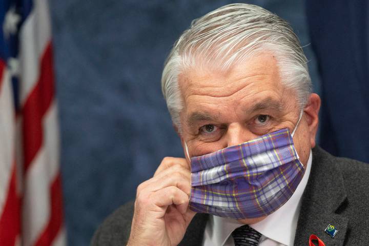 Gov. Steve Sisolak wears a protective mask before the start of a press conference, April 8, 202 ...