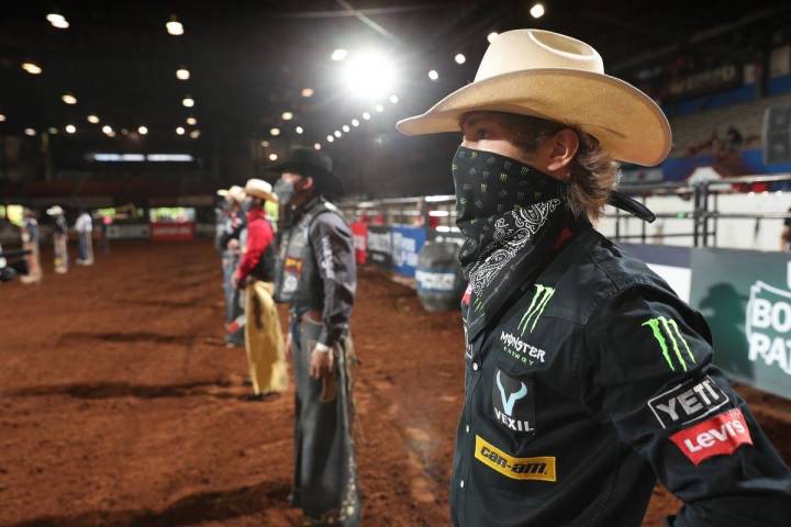 PBR bull rider Derek Kolbaba (foreground) and his fellow cowboys stand before the PBR becomes t ...