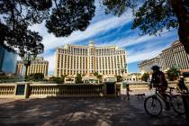 People take in the sights outside of the Bellagio along the Las Vegas Strip on Thursday, April ...