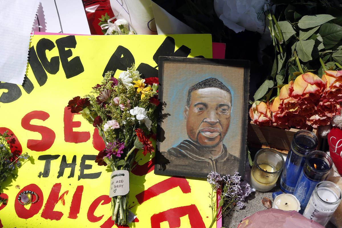 A chain portrait of George Floyd is part of the memorial for him, Wednesday, May 27, 2020, near ...