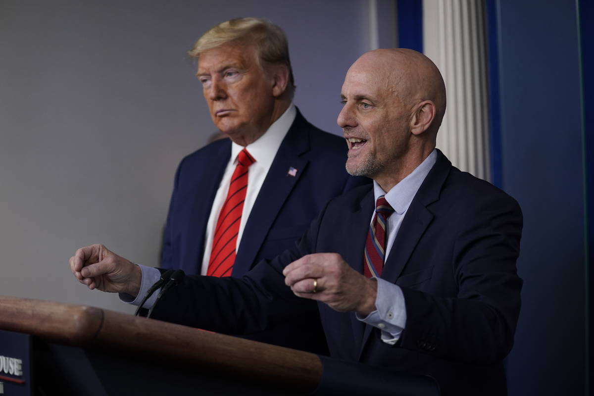 President Donald Trump, left, listens as Food and Drug Administration Commissioner Dr. Stephen ...