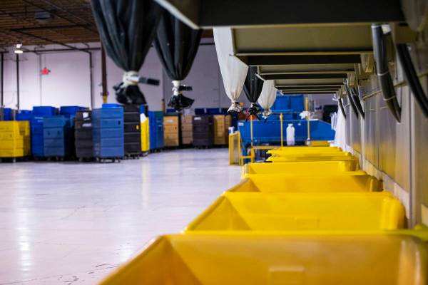 Bins await dried clothing and linens at the Western Linen Services laundry facility in Las Vega ...