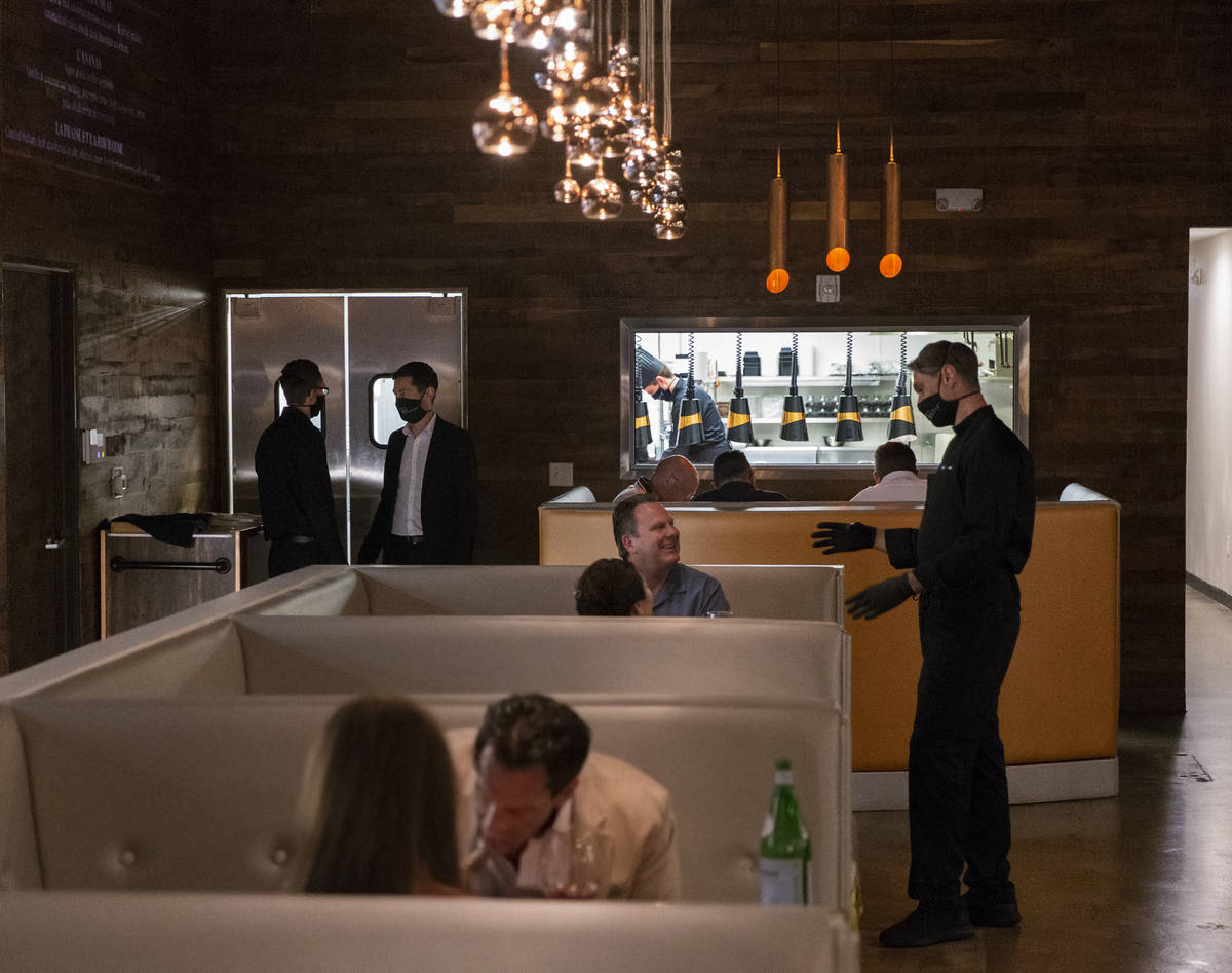 Chef Yuri Szarzewski, top/right, speaks with David and Lisa French during dinner service at Par ...