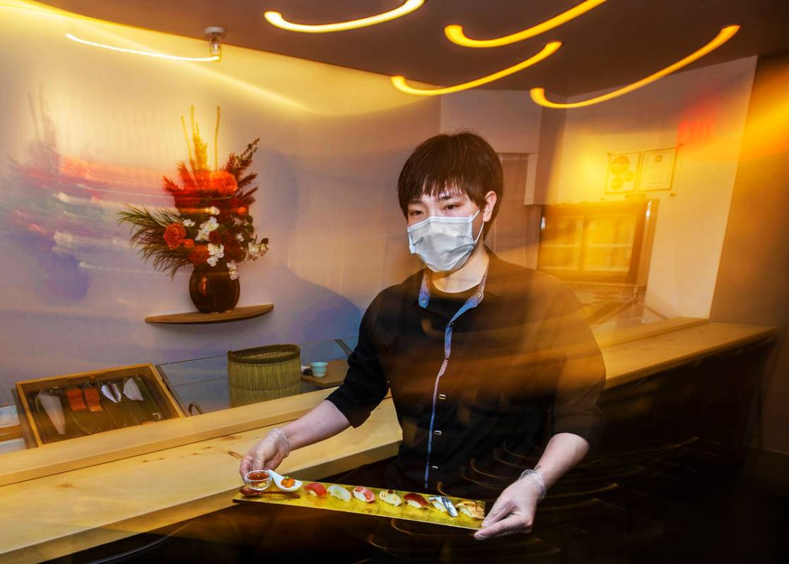 Roy Cheng serves food at Yui Edomae Sushi on Thursday, May 28, 2020, in Las Vegas. (Benjamin Ha ...