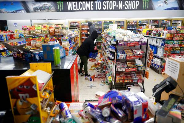 People loot a convenience store Friday, May 29, 2020, in Minneapolis. Protests continued follow ...