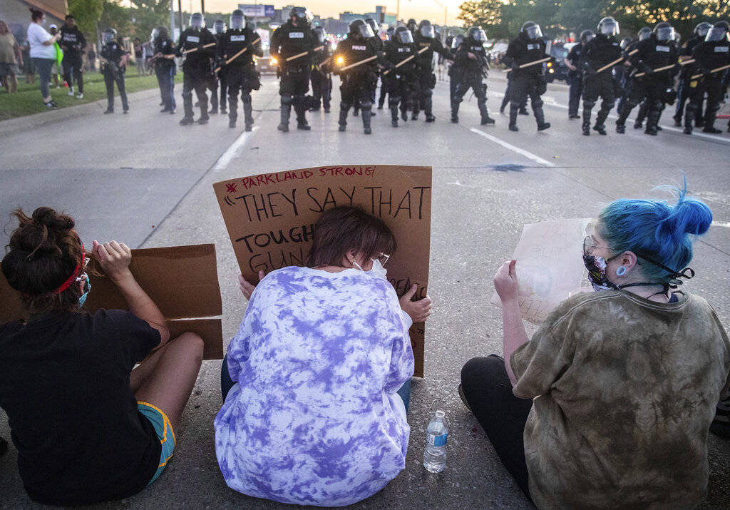 Omaha police fire tear gas as they approach protesters sitting in the eastbound lane of Dodge S ...