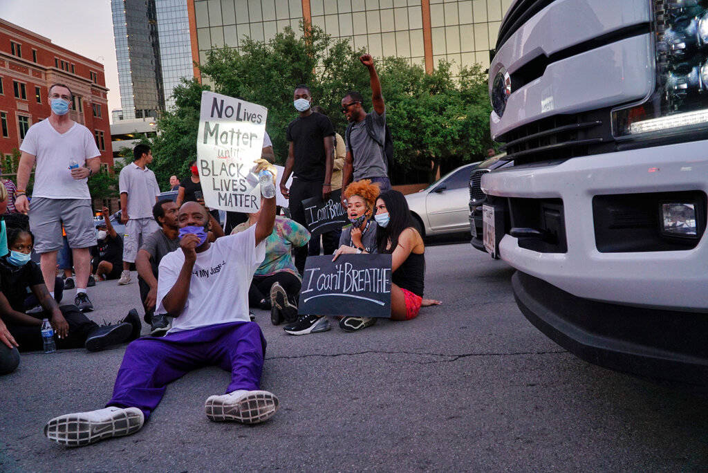 Donnell Ballard blocks traffic during a march in downtown Fort Worth, Texas on Friday, May 29, ...