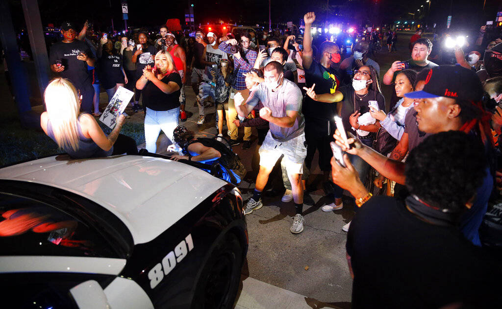 Protestors stop Dallas Police officers responding to a confrontation at Young St. and S. Griffi ...