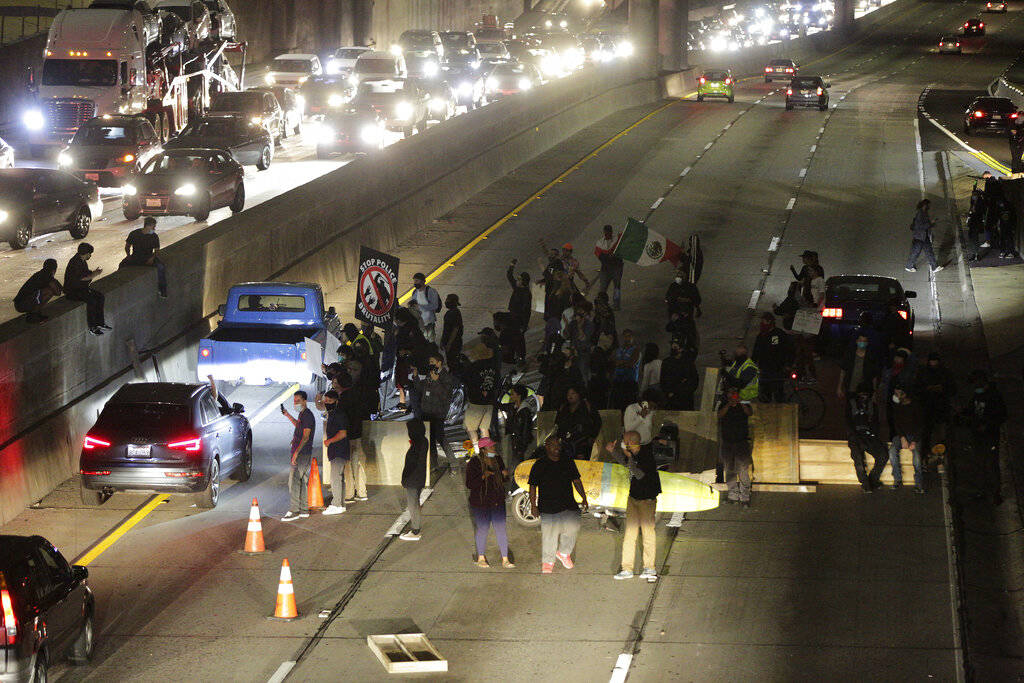 Demonstrators shut down the northbound CA-110 freeway to protest the killing of George Floyd, i ...