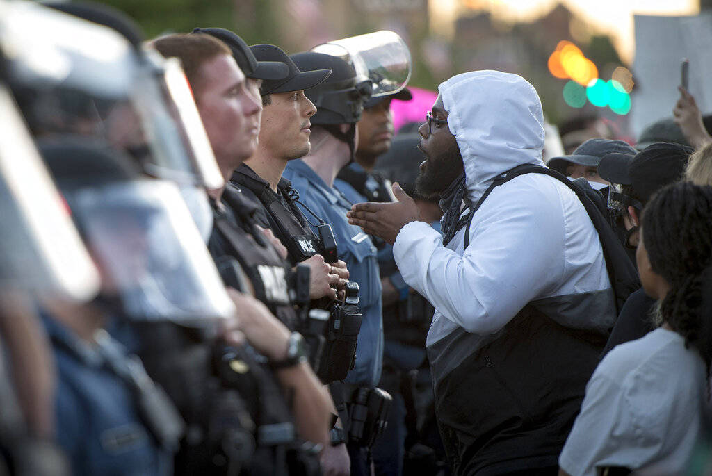 In this May 29, 2020, photo, a protester confronts Kansas City police during a George Floyd pro ...