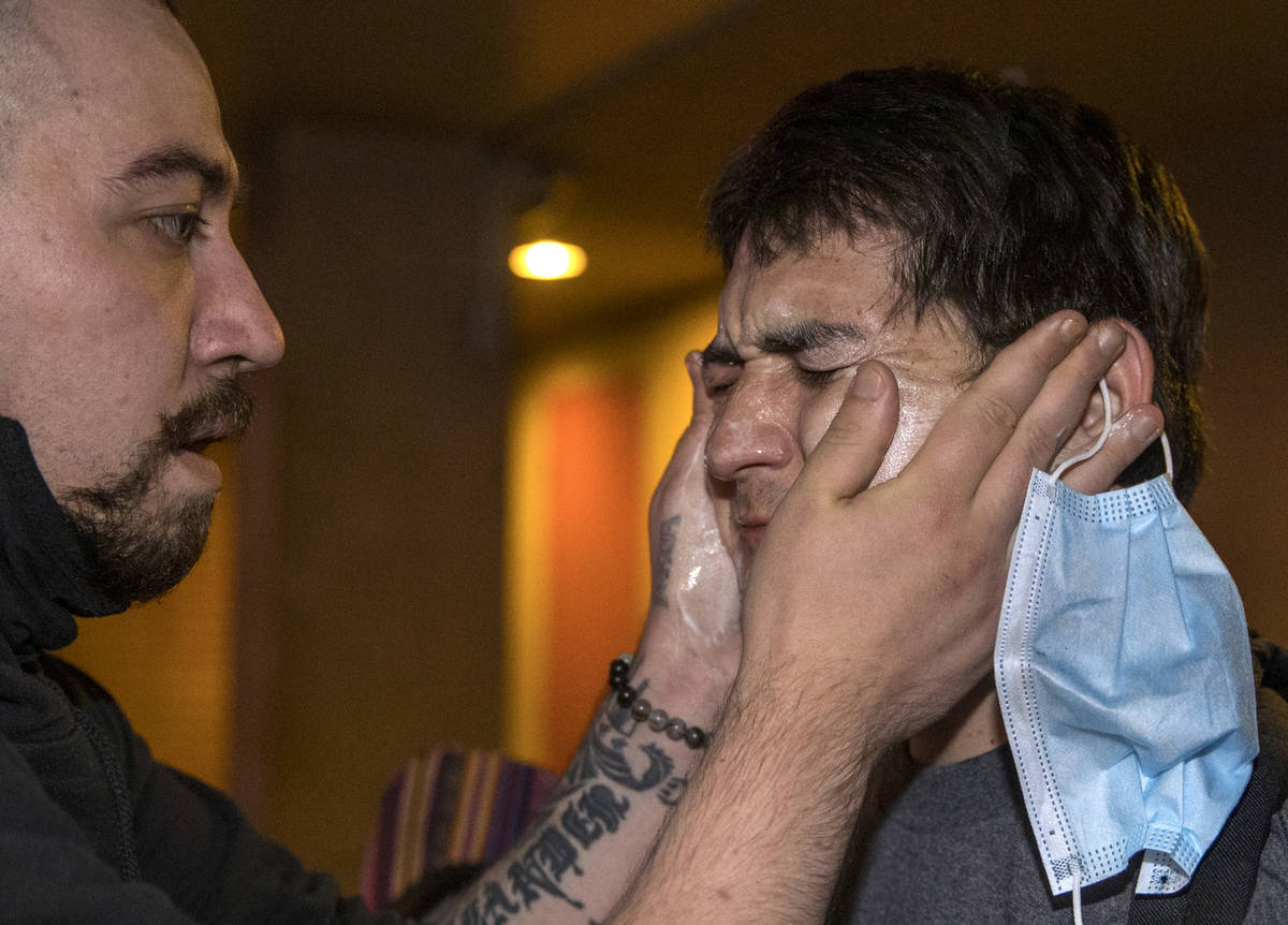 A protester, right, receives some medical attention after being tear gassed by Las Vegas Police ...