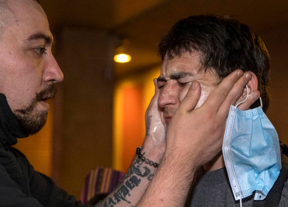 A protester, right, receives some medical attention after being tear gassed by Las Vegas Police ...