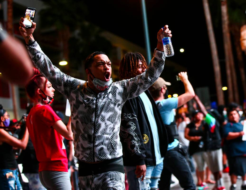 A man shouts at police while protesting the death of George Floyd in downtown Las Vegas on Satu ...