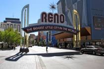 FILE - In this Oct. 11, 2016, file photo, pedestrians pass beneath the Reno arch as traffic pas ...