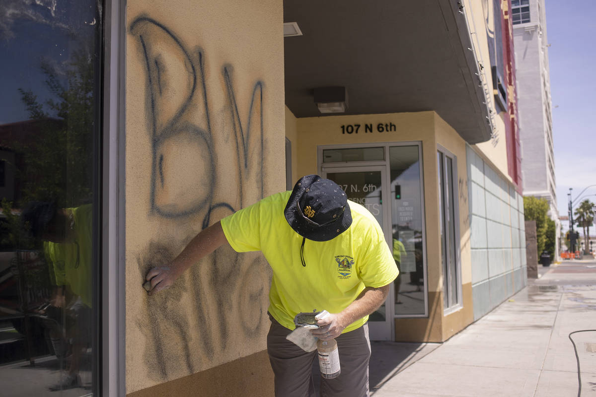 Sean Murphy cleans up graffiti at Eureka! Discover American Craft following a night of protests ...