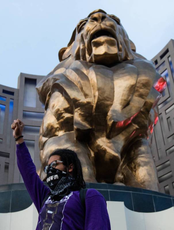 A demonstrator stands with his fist in the air outside MGM Grand on Sunday, May 31, 2020, in La ...