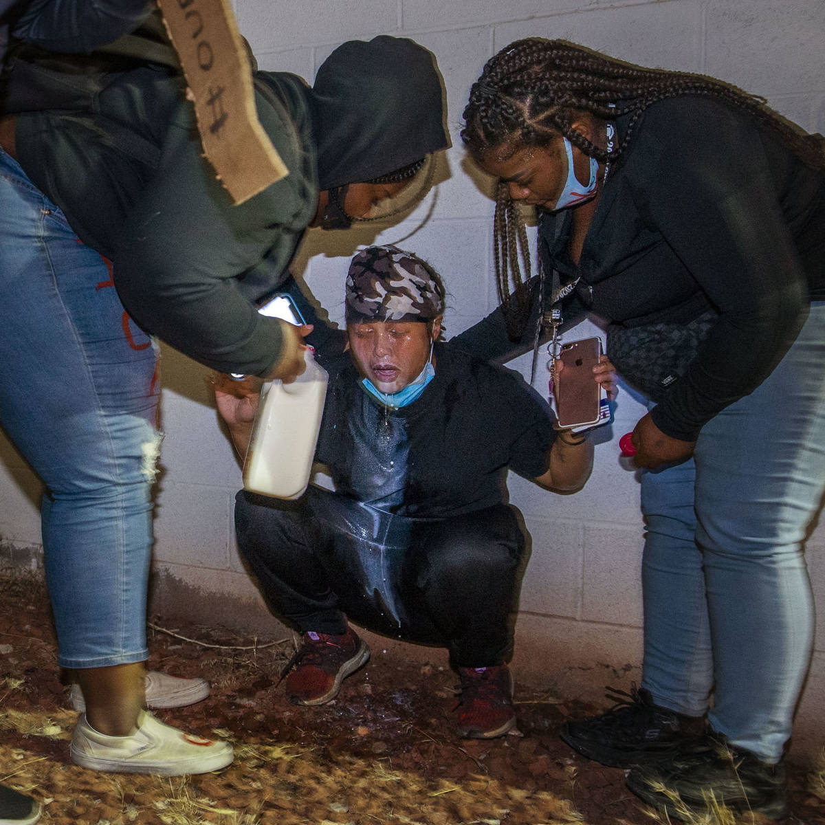 Protesters come to the aid of another who was tear gassed by Las Vegas police during a Black Li ...